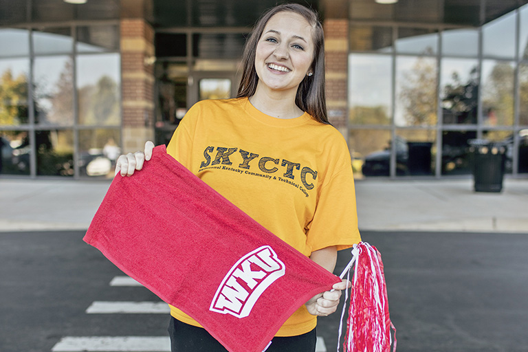 female student in SKYCTC shirt holding WKU towel